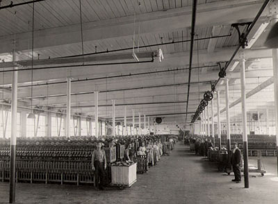 Workers in a large room in the mills